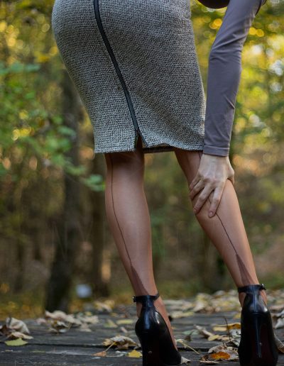 Mrs NyloNova wearing pencil skirt, copper coloured cuban heel Secrets in Lace nylon stockings. Black ankle strap high heels Ryłko.