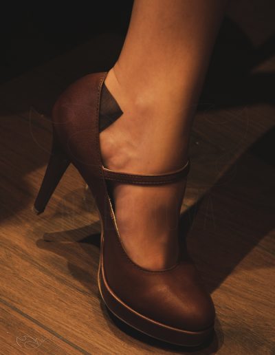 Mrs NyloNova wearing nude nylon stockings Eleganti in cinema waiting room. Contrast welt. Brown ankle strap high heels Aranci.